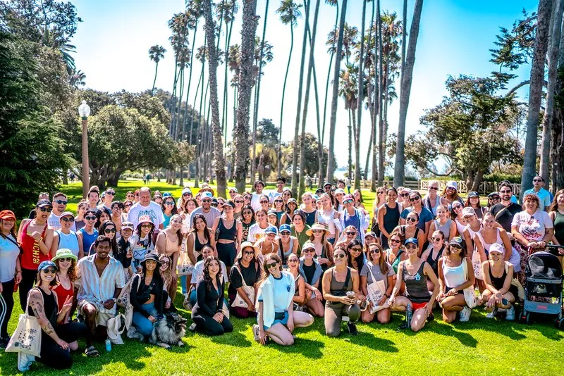 Event crowd group photo under palm trees